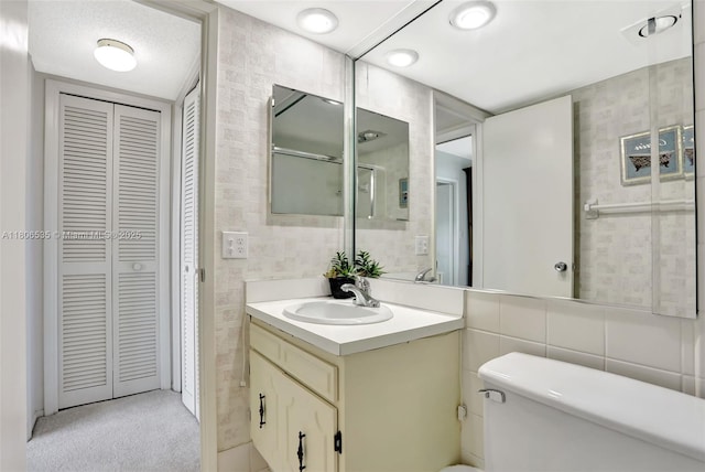 3091 N Course Dr Unit 502, Pompano Beach, FL 33069 - bathroom featuring a closet, tile walls, toilet, and vanity