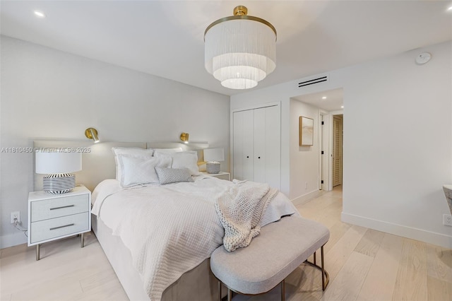 725 Biltmore Ct, Coral Gables, FL 33134 - bedroom with light wood-style flooring, a closet, baseboards, recessed lighting, and a chandelier