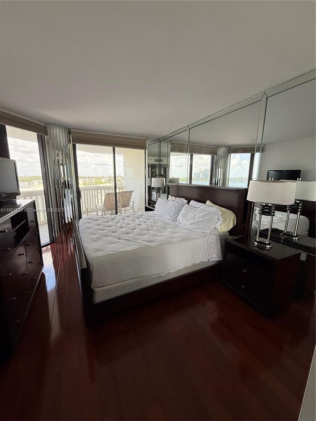 1000 Island Blvd Unit 911, Aventura, FL 33160 - bedroom featuring access to exterior and dark wood-style flooring