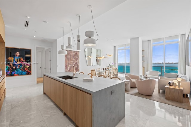 725 NE 22nd St Unit Ph3C, Miami, FL 33137 - kitchen with modern cabinets, a sink, a large island, a water view, and light marble finish floors