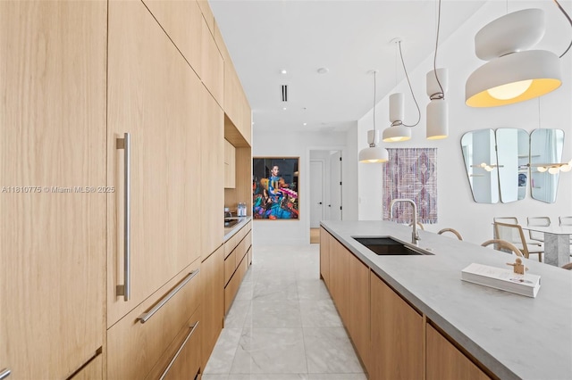 725 NE 22nd St Unit Ph3C, Miami, FL 33137 - kitchen featuring a sink, modern cabinets, light marble finish floors, hanging light fixtures, and light countertops