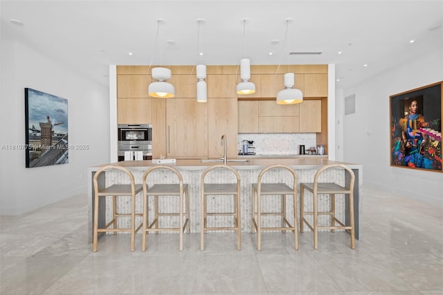 725 NE 22nd St Unit Ph3C, Miami, FL 33137 - kitchen with a sink, modern cabinets, light brown cabinets, and recessed lighting