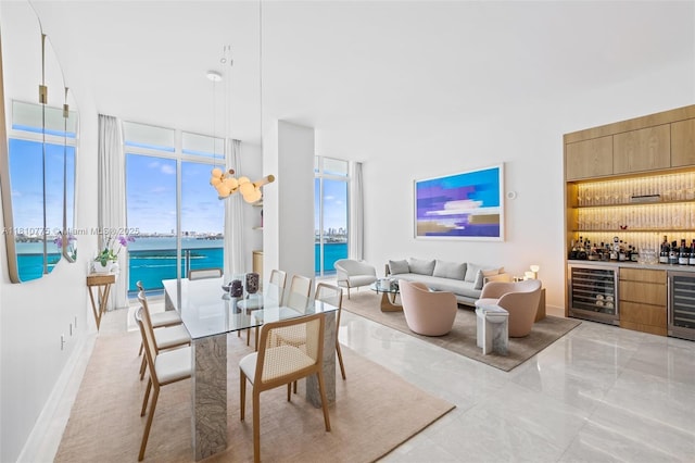725 NE 22nd St Unit Ph3C, Miami, FL 33137 - dining space with beverage cooler, a bar, a water view, and light marble finish flooring