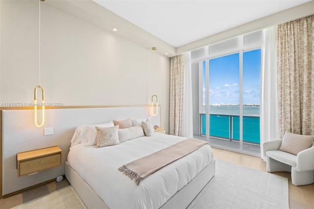 725 NE 22nd St Unit Ph3C, Miami, FL 33137 - bedroom with access to outside, a water view, floor to ceiling windows, and wood finished floors