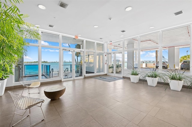 725 NE 22nd St Unit Ph3C, Miami, FL 33137 - common area with expansive windows, a water view, and recessed lighting