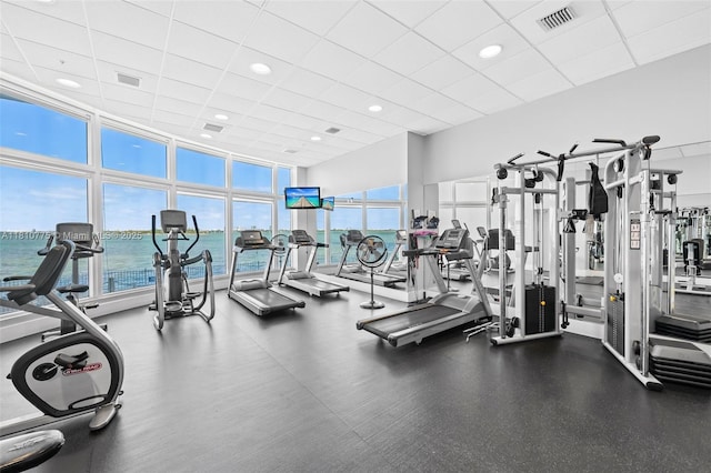 725 NE 22nd St Unit Ph3C, Miami, FL 33137 - exercise room featuring a paneled ceiling, a water view, and recessed lighting