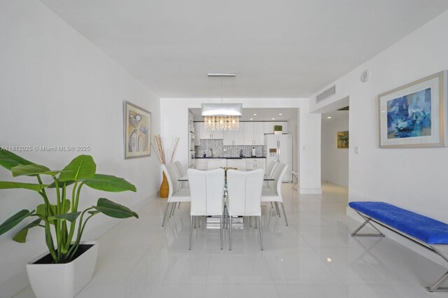 19370 Collins Ave Unit 902, Sunny Isles Beach, FL 33160 - dining area featuring a chandelier and light tile patterned floors