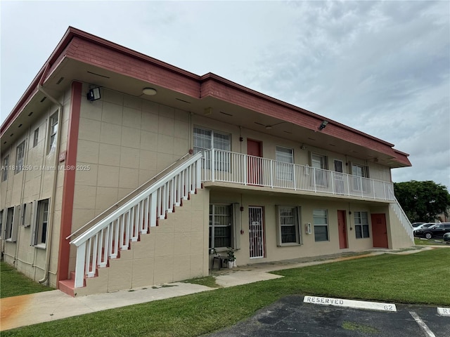 12801 SW 43rd Dr Unit 212-A, Miami, FL 33175 - view of building exterior with stairs and uncovered parking