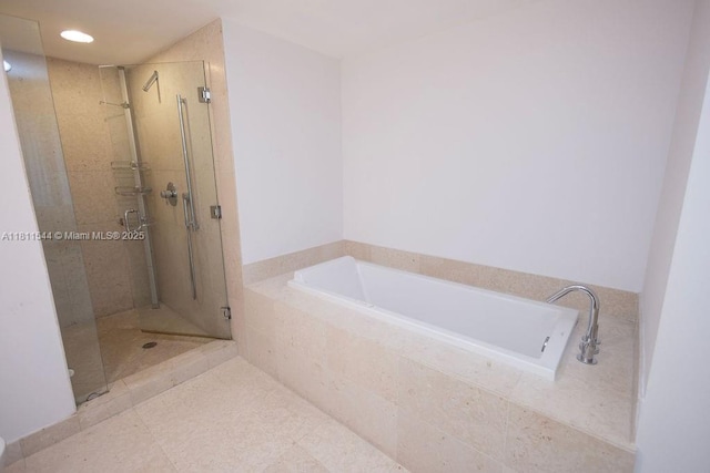 475 Brickell Ave Unit 1715, Miami, FL 33131 - bathroom featuring a shower stall, a garden tub, and recessed lighting