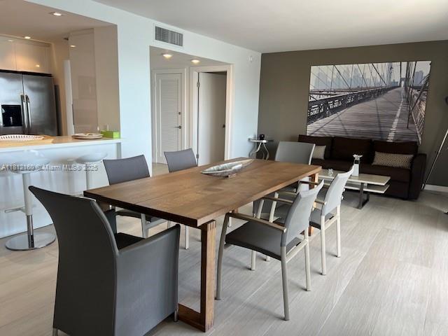 11111 Biscayne Blvd Unit 8C, Miami, FL 33181 - dining space featuring light wood-style flooring and recessed lighting