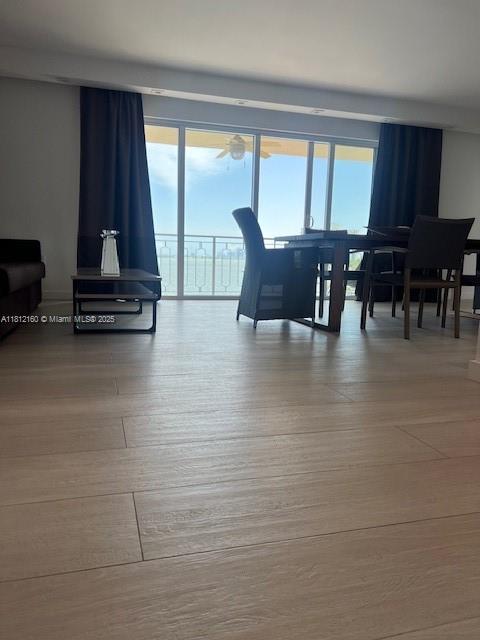 11111 Biscayne Blvd Unit 8C, Miami, FL 33181 - living area featuring plenty of natural light, ceiling fan, and wood finished floors
