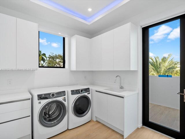 401 Bontona Ave, Fort Lauderdale, FL 33301 - washroom featuring cabinet space, washing machine and dryer, light wood-style flooring, and recessed lighting