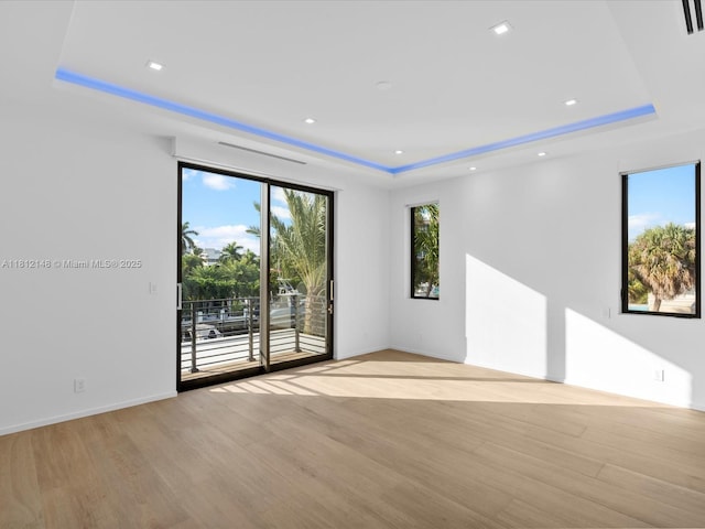 401 Bontona Ave, Fort Lauderdale, FL 33301 - unfurnished room with a raised ceiling, light wood-style floors, and baseboards