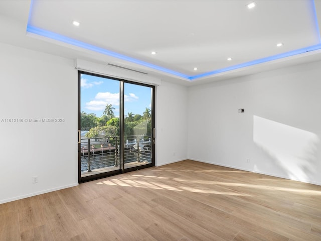 401 Bontona Ave, Fort Lauderdale, FL 33301 - empty room featuring a tray ceiling, light wood-type flooring, baseboards, and recessed lighting