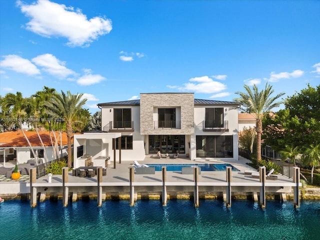 401 Bontona Ave, Fort Lauderdale, FL 33301 - back of property featuring a balcony, a standing seam roof, and a patio area