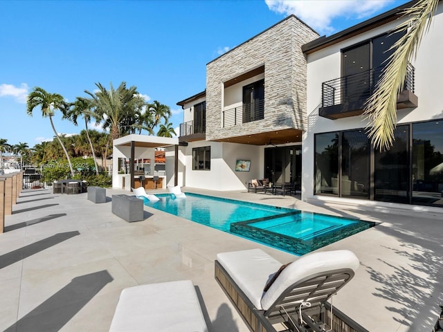 401 Bontona Ave, Fort Lauderdale, FL 33301 - rear view of property with stone siding, a balcony, area for grilling, stucco siding, and a patio
