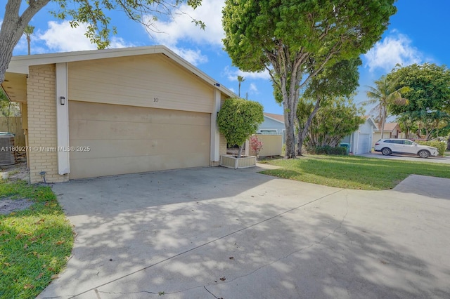 10 Afton Pl, Boynton Beach, FL 33426 - view of front of home with brick siding, concrete driveway, central air condition unit, and a front yard