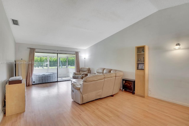 10 Afton Pl, Boynton Beach, FL 33426 - living area featuring vaulted ceiling, light wood-style flooring, and baseboards