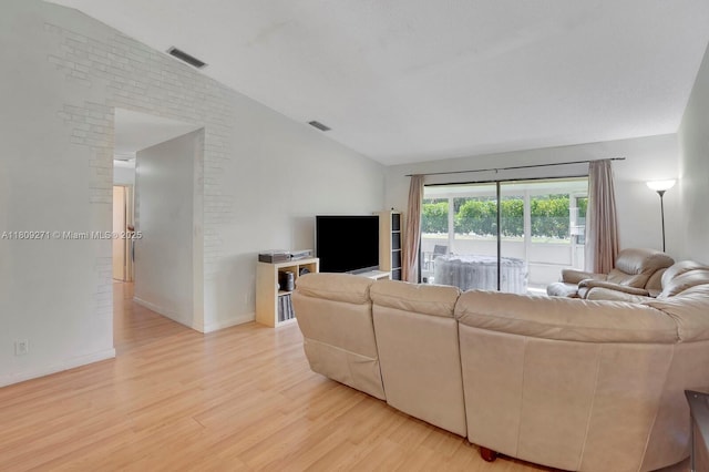 10 Afton Pl, Boynton Beach, FL 33426 - living area with lofted ceiling, light wood finished floors, and baseboards