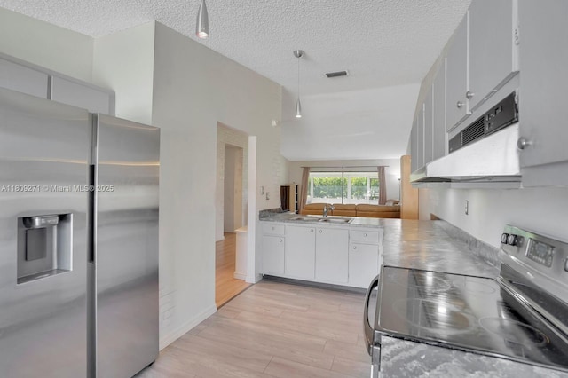 10 Afton Pl, Boynton Beach, FL 33426 - kitchen with stainless steel appliances, a sink, light wood-style floors, white cabinets, and extractor fan