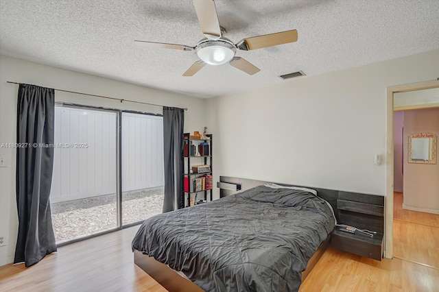 10 Afton Pl, Boynton Beach, FL 33426 - bedroom featuring wood finished floors, a textured ceiling, access to exterior, and ceiling fan