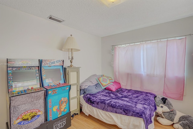 10 Afton Pl, Boynton Beach, FL 33426 - bedroom with wood finished floors and a textured ceiling