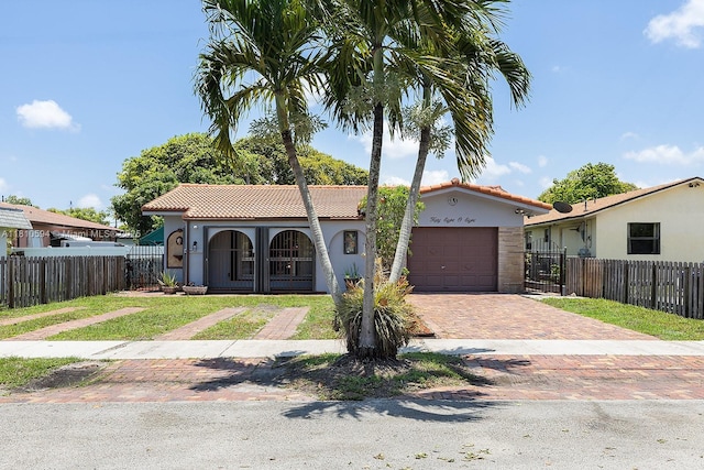 5808 Polk St, Hollywood, FL 33021 - mediterranean / spanish-style house featuring decorative driveway, a tile roof, a garage, and stucco siding