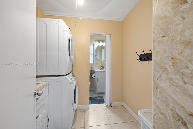 5808 Polk St, Hollywood, FL 33021 - laundry room with stacked washer and clothes dryer, light tile patterned floors, ornamental molding, and baseboards