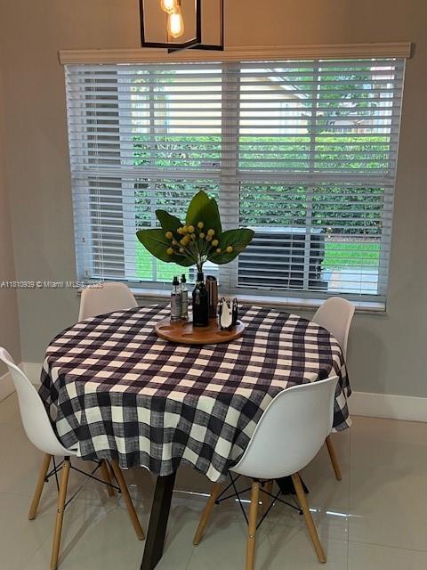 1020 Silktree Ln, Weston, FL 33327 - tiled dining room featuring baseboards