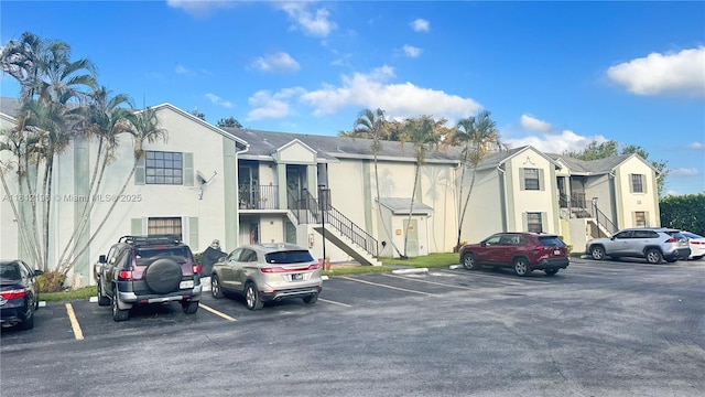 1331 S Franklin Ave Unit 1331E, Homestead, FL 33034 - view of building exterior featuring stairs, uncovered parking, and a residential view