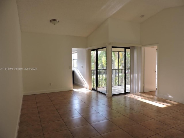 1331 S Franklin Ave Unit 1331E, Homestead, FL 33034 - empty room with tile patterned floors, baseboards, and high vaulted ceiling