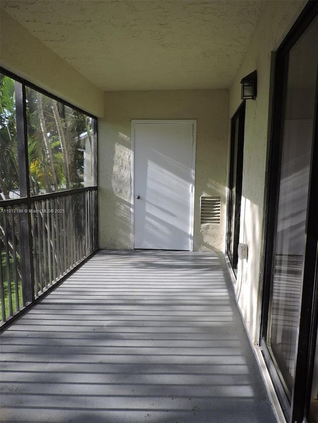 1331 S Franklin Ave Unit 1331E, Homestead, FL 33034 - unfurnished sunroom with a textured ceiling and wood finished floors