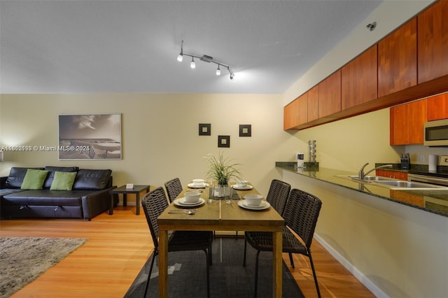 1200 Brickell Bay Dr Unit 2120, Miami, FL 33131 - dining space with light wood-type flooring and baseboards