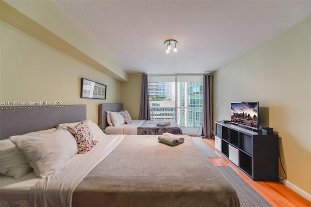 1200 Brickell Bay Dr Unit 2120, Miami, FL 33131 - bedroom featuring wood finished floors and a wall of windows