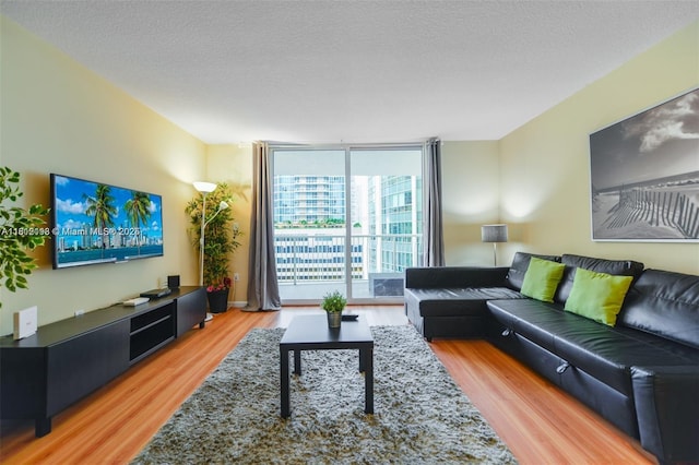 1200 Brickell Bay Dr Unit 2120, Miami, FL 33131 - living room with light wood finished floors, floor to ceiling windows, and a textured ceiling