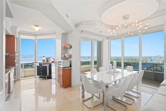 4775 Collins Ave Unit Ph4107, Miami Beach, FL 33140 - dining room featuring a chandelier, plenty of natural light, and a water view