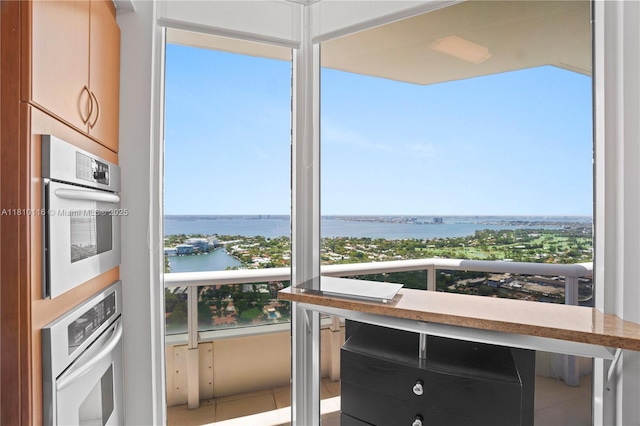 4775 Collins Ave Unit Ph4107, Miami Beach, FL 33140 - kitchen featuring a water view and tile patterned flooring