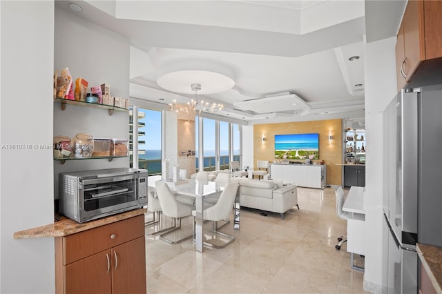 4775 Collins Ave Unit Ph4107, Miami Beach, FL 33140 - dining room featuring a tray ceiling, a chandelier, crown molding, and recessed lighting