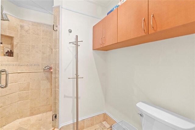 4775 Collins Ave Unit Ph4107, Miami Beach, FL 33140 - bathroom featuring toilet, a shower stall, and crown molding