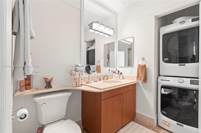 4775 Collins Ave Unit Ph4107, Miami Beach, FL 33140 - half bath with stacked washer and clothes dryer, vanity, and toilet