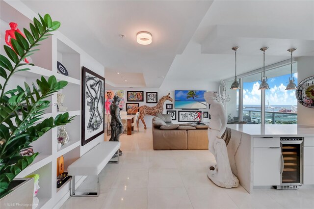 650 W Ave Unit Ph09, Miami Beach, FL 33139 - kitchen with white cabinets, beverage cooler, light countertops, pendant lighting, and light tile patterned floors