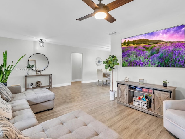 11610 NW 32nd Mnr, Sunrise, FL 33323 - living room featuring light wood finished floors, ceiling fan, and baseboards