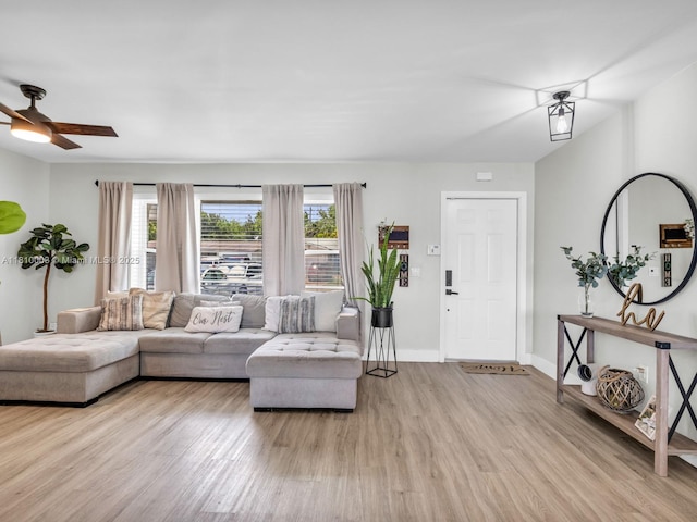 11610 NW 32nd Mnr, Sunrise, FL 33323 - living area featuring light wood-type flooring, healthy amount of natural light, a ceiling fan, and baseboards
