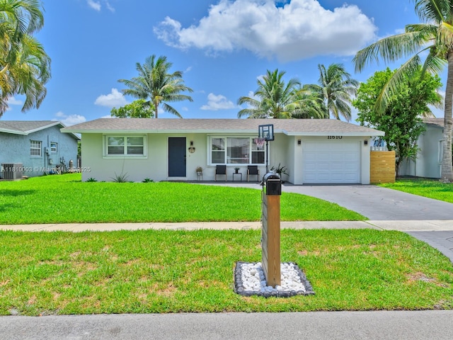 11610 NW 32nd Mnr, Sunrise, FL 33323 - single story home with a garage, stucco siding, concrete driveway, and central air condition unit