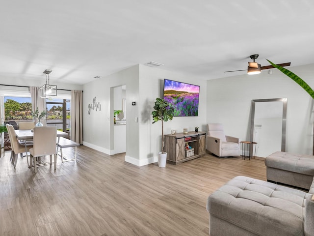 11610 NW 32nd Mnr, Sunrise, FL 33323 - living area featuring baseboards, light wood finished floors, and ceiling fan