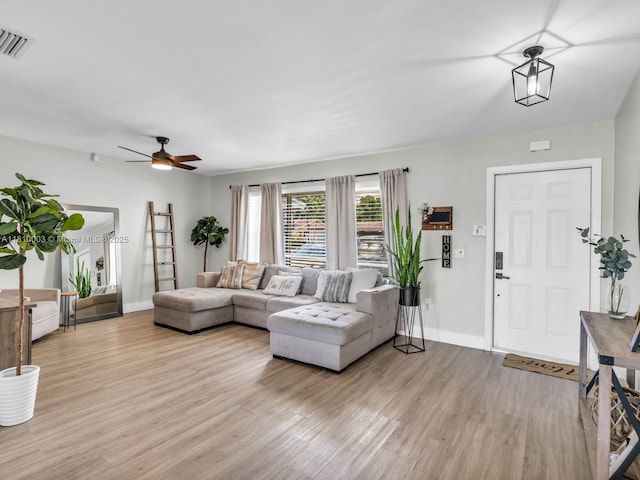 11610 NW 32nd Mnr, Sunrise, FL 33323 - living room featuring light wood-style flooring, baseboards, and a ceiling fan