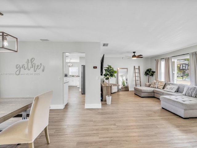 11610 NW 32nd Mnr, Sunrise, FL 33323 - living area featuring light wood-style flooring, a ceiling fan, and baseboards