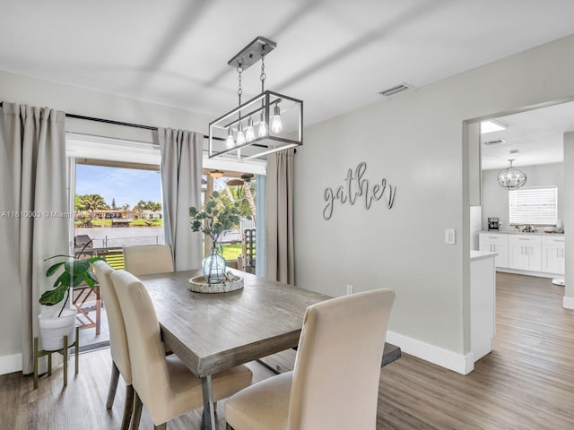 11610 NW 32nd Mnr, Sunrise, FL 33323 - dining room with a chandelier, plenty of natural light, and wood finished floors