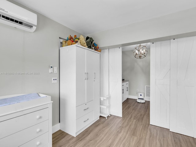 11610 NW 32nd Mnr, Sunrise, FL 33323 - unfurnished bedroom featuring an AC wall unit, light wood finished floors, baseboards, and a chandelier