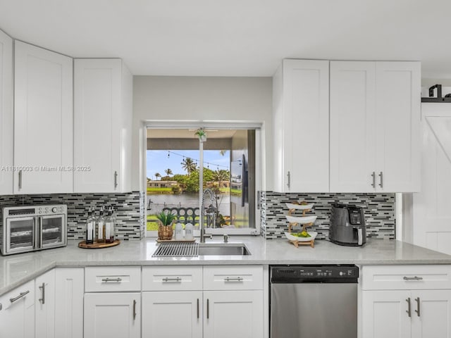 11610 NW 32nd Mnr, Sunrise, FL 33323 - kitchen featuring dishwasher, tasteful backsplash, a sink, and white cabinets